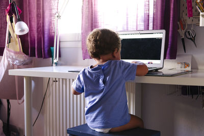 Young child watching videos on a laptop