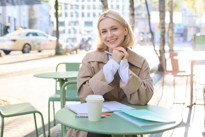 Young woman using mobile phone in cafe