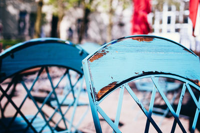 Close-up of blue chairs at sidewalk cafe