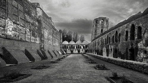 View of old building against cloudy sky