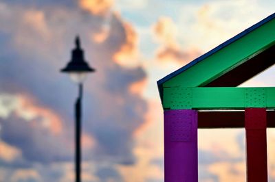 Low angle view of illuminated street light against sky