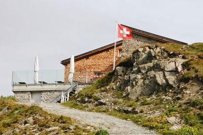 Flag on built structure against sky