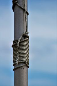 Low angle view of metal pole against sky