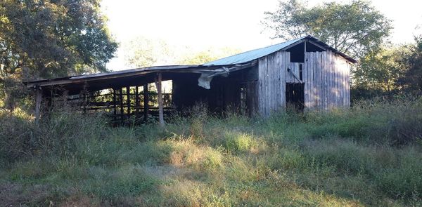 Abandoned built structure on landscape against clear sky