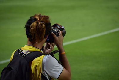 Rear view of woman photographing