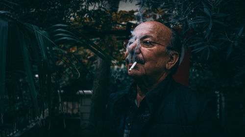 Portrait of man looking away outdoors at night