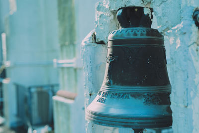 Close-up of bell hanging at church during winter