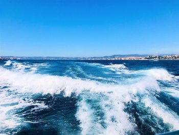 Scenic view of sea against clear blue sky