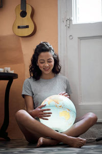 Fight today for a better tomorrow. young woman with a world globe.