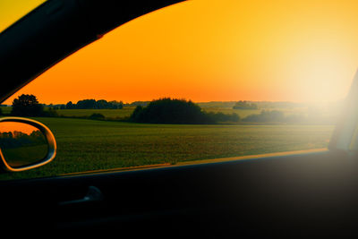 Scenic view of field against sky during sunset