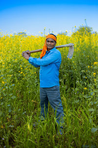 Portrait of man standing on field