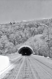 Road passing through snow covered landscape
