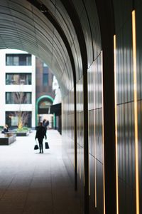 Rear view of people walking in building