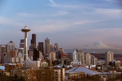 View of cityscape against cloudy sky