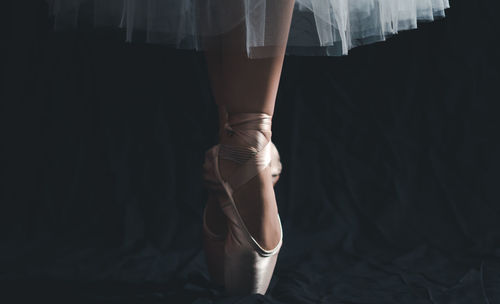 Low section of ballerina standing on tip toes