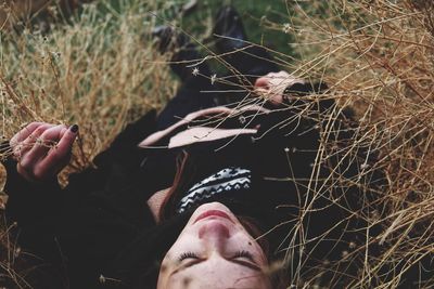 Woman lying down on dry plants