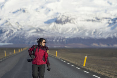 Women walking on road against sky