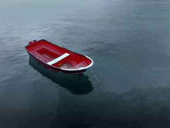 High angle view of red boat moored in lake