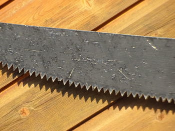 High angle view of barbed wire on wooden table