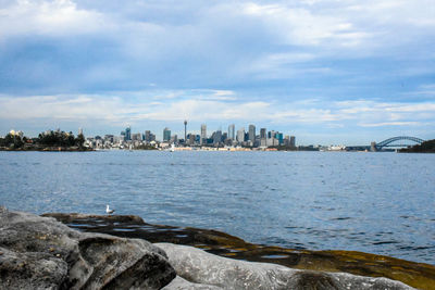 Scenic view of sea by city against sky
