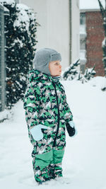 Cute boy standing in snow