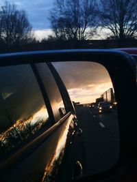 Cars on road at sunset