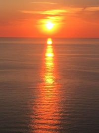 Scenic view of sea against orange sky