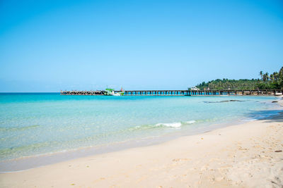 Scenic view of beach against clear blue sky