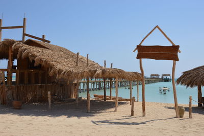 Lifeguard hut on beach against clear sky