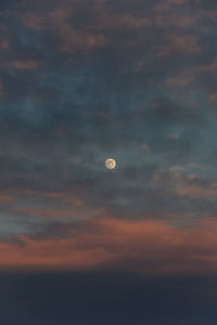 Low angle view of moon against sky at sunset