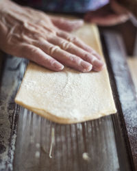 Close-up of person preparing food on table