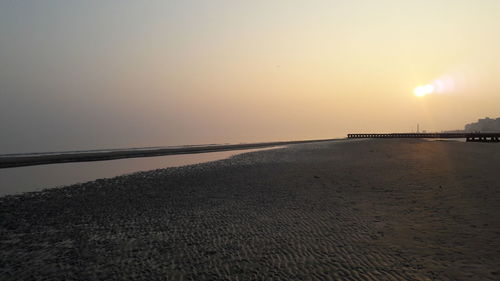 Scenic view of beach against sky during sunset