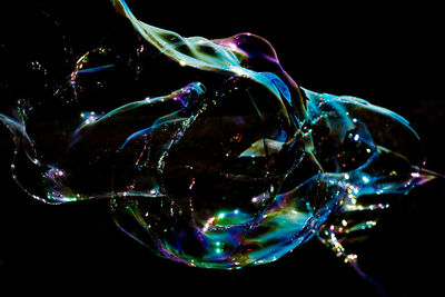 Close-up of bubbles against black background