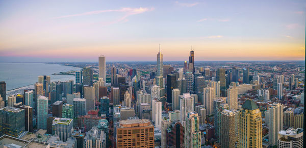 Aerial view of cityscape against sky during sunset