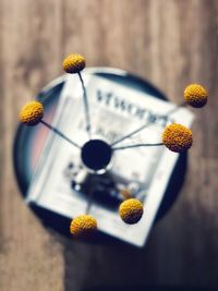 Side table with magazine and yellow flowers