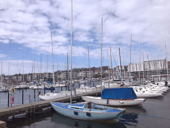 Sailboats moored in harbor