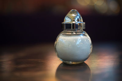 Close-up of salt shaker on table