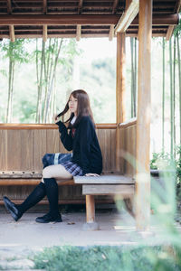 Woman sitting on chair in table