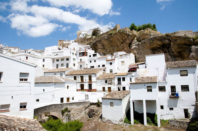 Buildings in town against sky