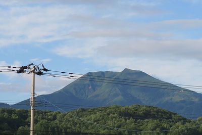 Low angle view of telephone pole against sky
