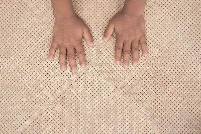 Cropped hand on person on wicker container