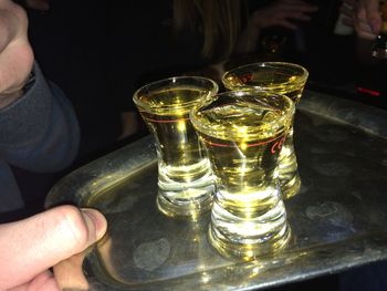 Close-up of hand holding beer glass