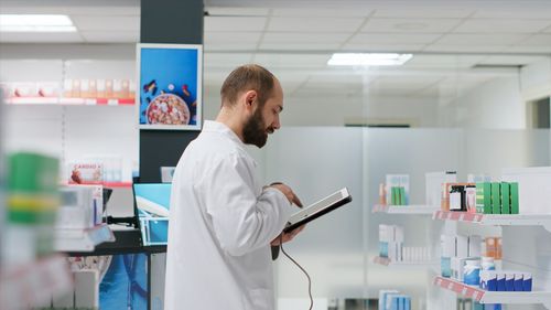 Female doctor examining chemical in laboratory