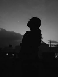 Silhouette man standing against sky during sunset