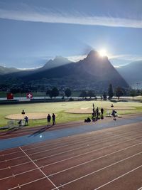 People on mountain range against sky