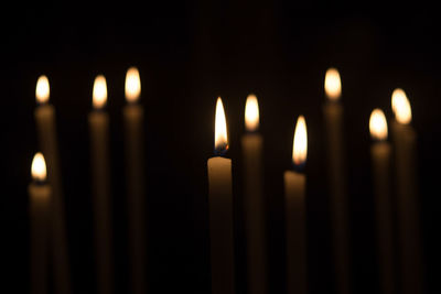 Close-up of lit candles in temple