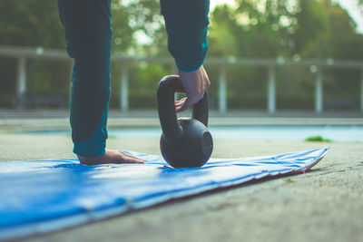 Woman exercising with kettlebell outdoors