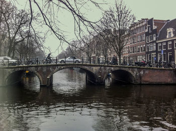 Bridge over river with buildings in background