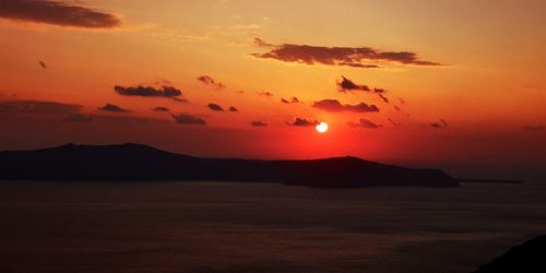 Scenic view of sea against romantic sky at sunset