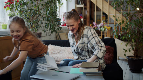 Mother teaching daughter at home